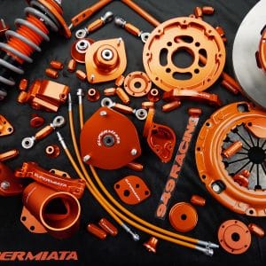 Orange SuperMiata car performance parts collection.