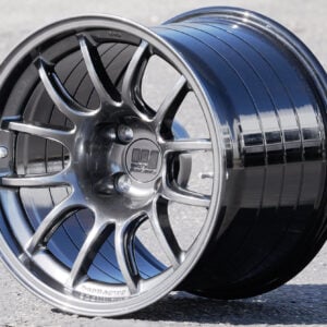 Glossy alloy car wheel rim on pavement