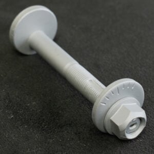 Gray bolt with washer and nut on black surface