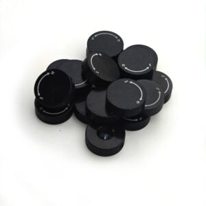 Black adjustment knobs stacked on white background