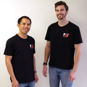 Two men wearing black 949 Racing shirts