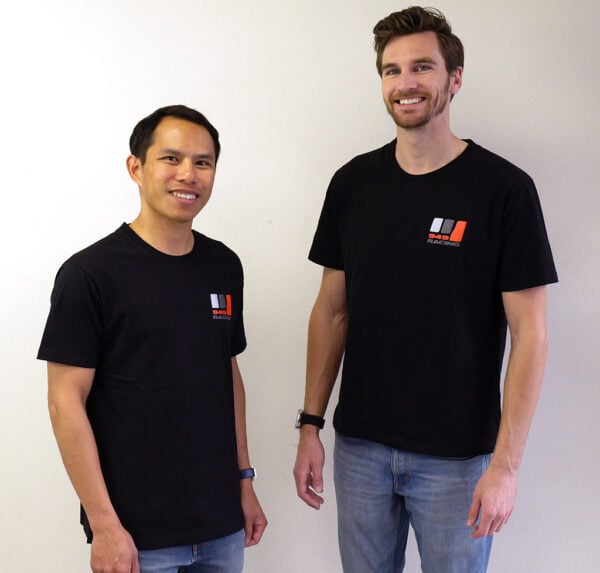 Two men wearing black 949 Racing shirts